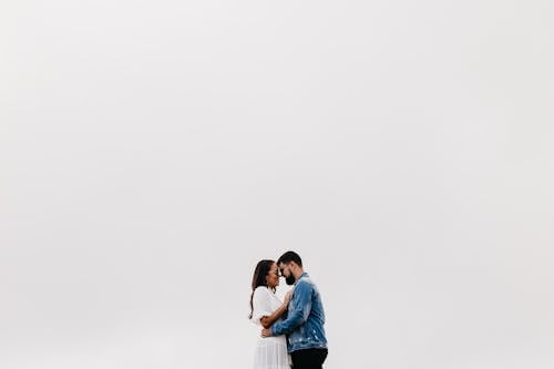 Couple Hugging Against White Background