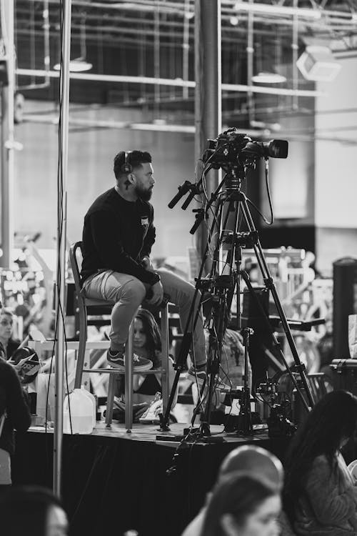 Camera Operator Sitting on Platform