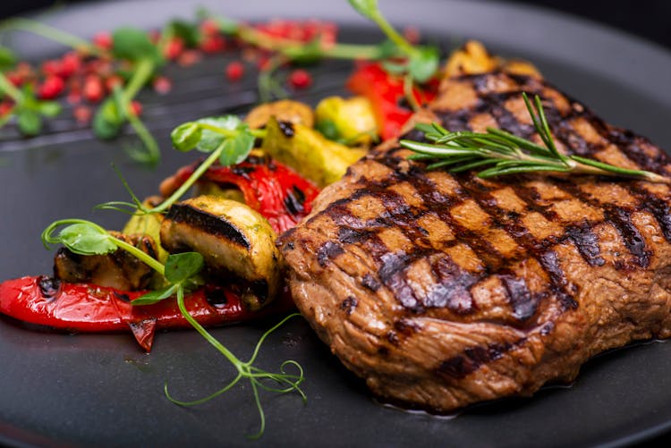 Grilled Meat And Vegetables With Herb Garnish