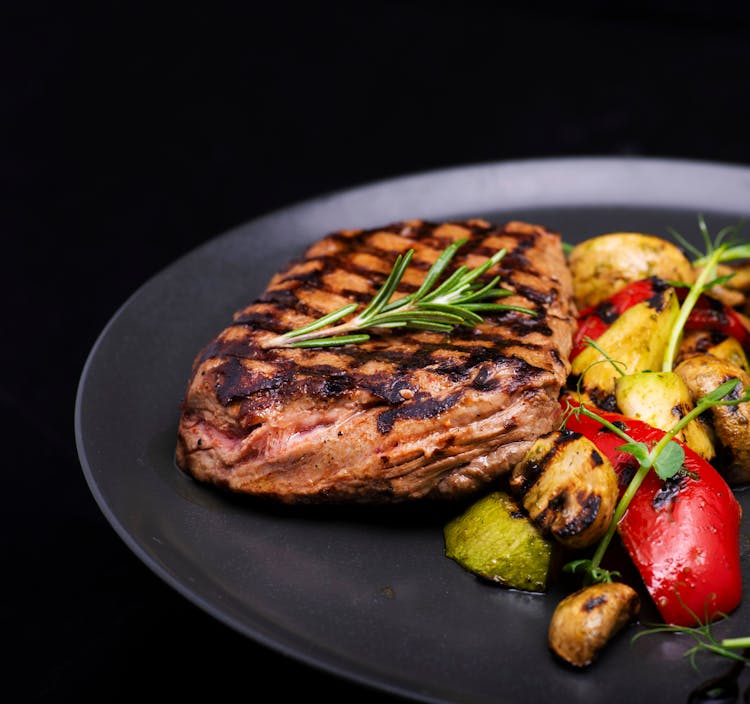 Grilled Steak On A Black Plate