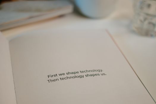 Open book with quote on technology's influence, perfect for tech inspiration.