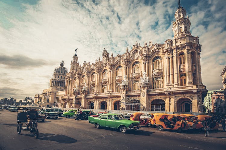 Moving Cars Beside A Theater Building