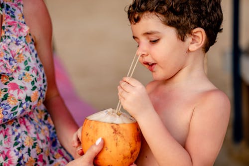 Topless Boy Holding a Coconut Fruit