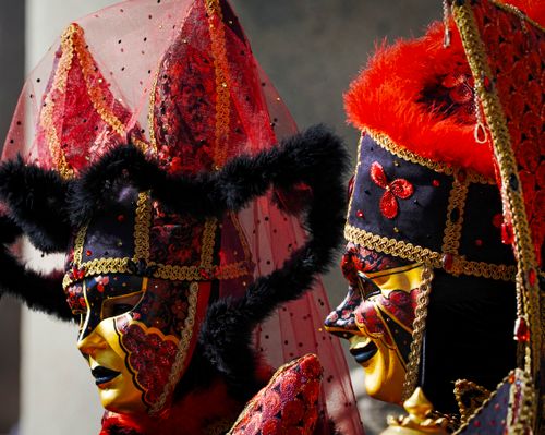 Free Detailed close-up of ornate Venetian masks with red and black designs, embodying the elegance of Venice's carnival. Stock Photo