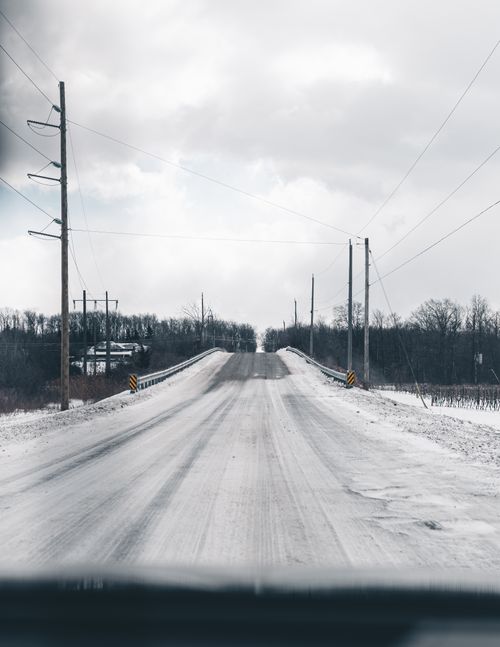 Free A frosty winter road in Ontario, showcasing a serene snowy landscape. Stock Photo