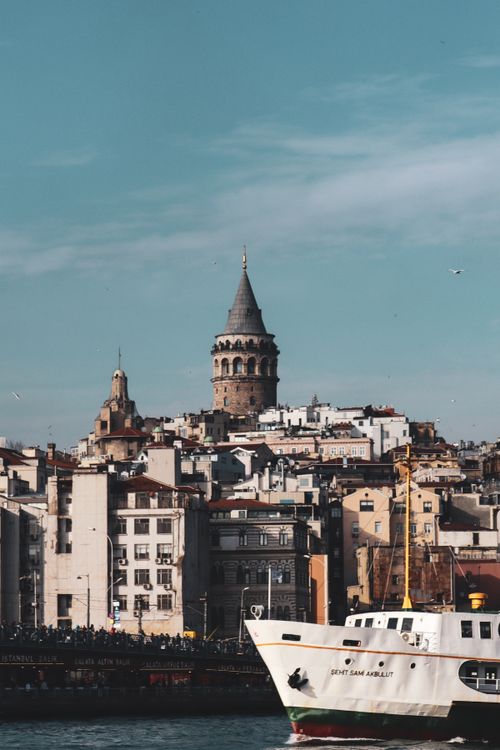 Free Scenic view of Galata Tower with cityscape and boat on the Bosphorus, Istanbul, Turkey. Stock Photo
