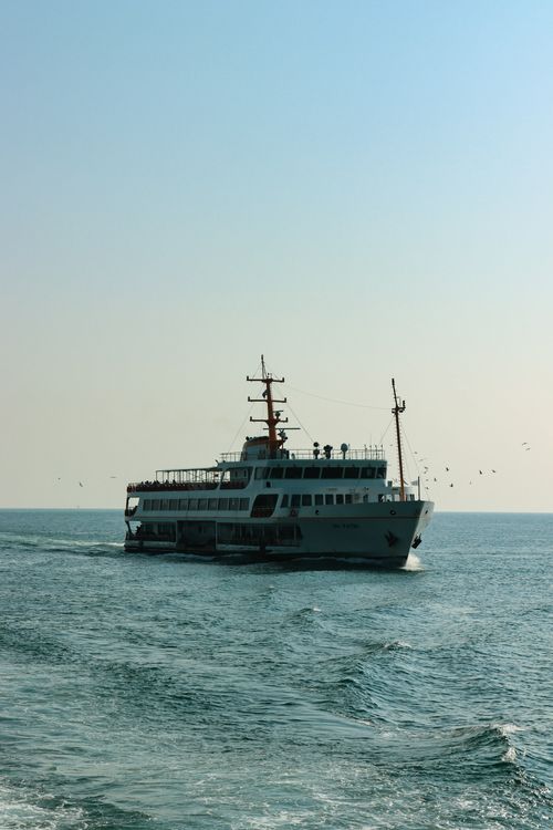 Free A scenic view of a passenger ferry cruising on the Bosphorus Strait in Istanbul under a clear sky. Stock Photo