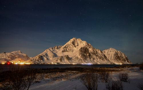 Free Captivating view of a starry night sky over snow-covered mountains in Nordland, Norway. Stock Photo