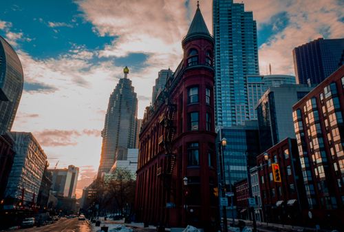 Free Beautiful winter sunset with Toronto's historic Flatiron Building surrounded by skyscrapers. Stock Photo