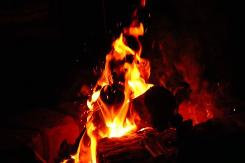 Free A close-up of warm campfire flames at night, perfect for a cozy outdoor setting. Stock Photo