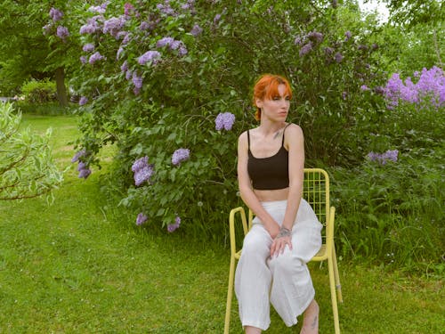 Woman Sitting on a Chair in the Garden