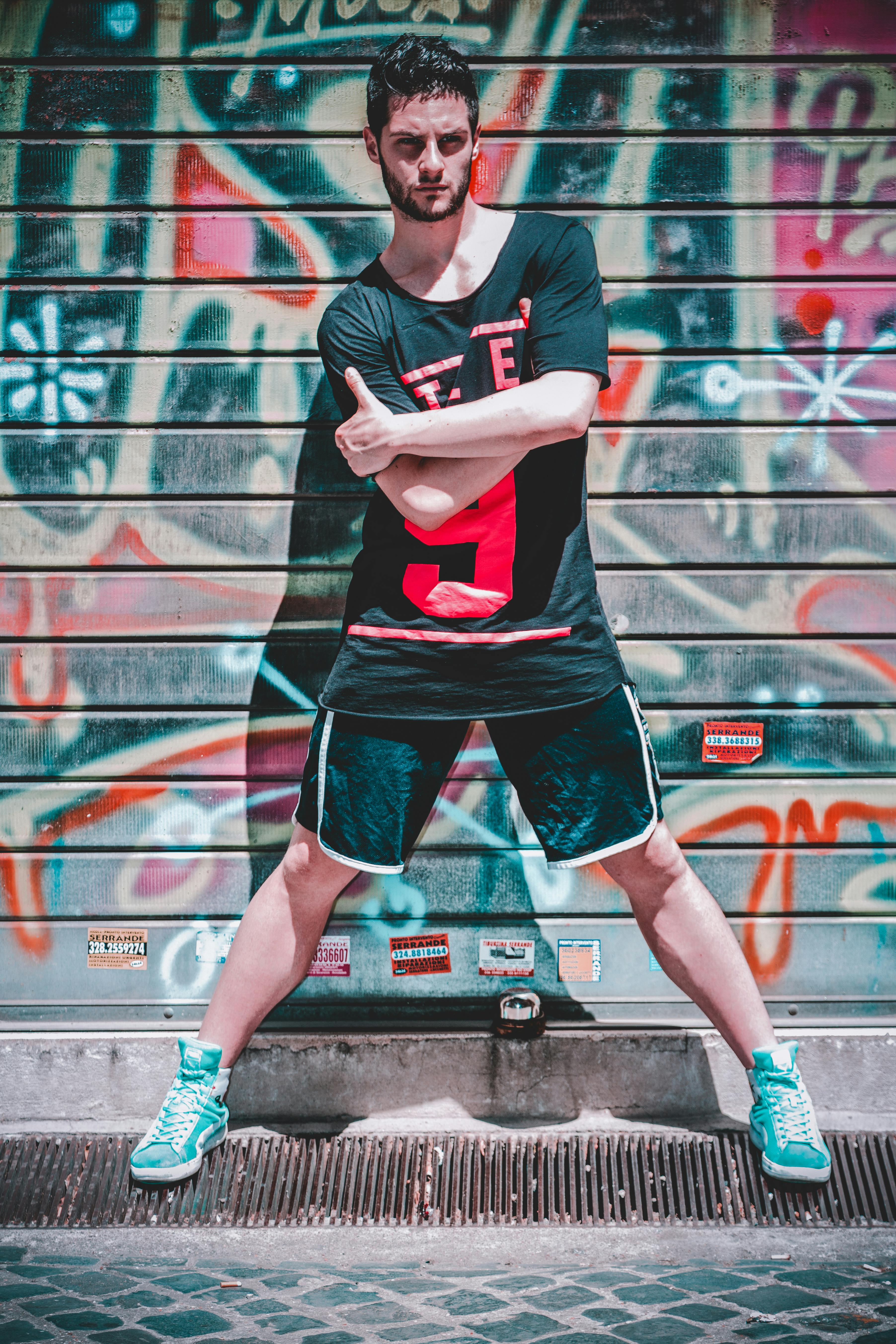 Man Wearing Black Black T-shirt and Black Gym Shorts