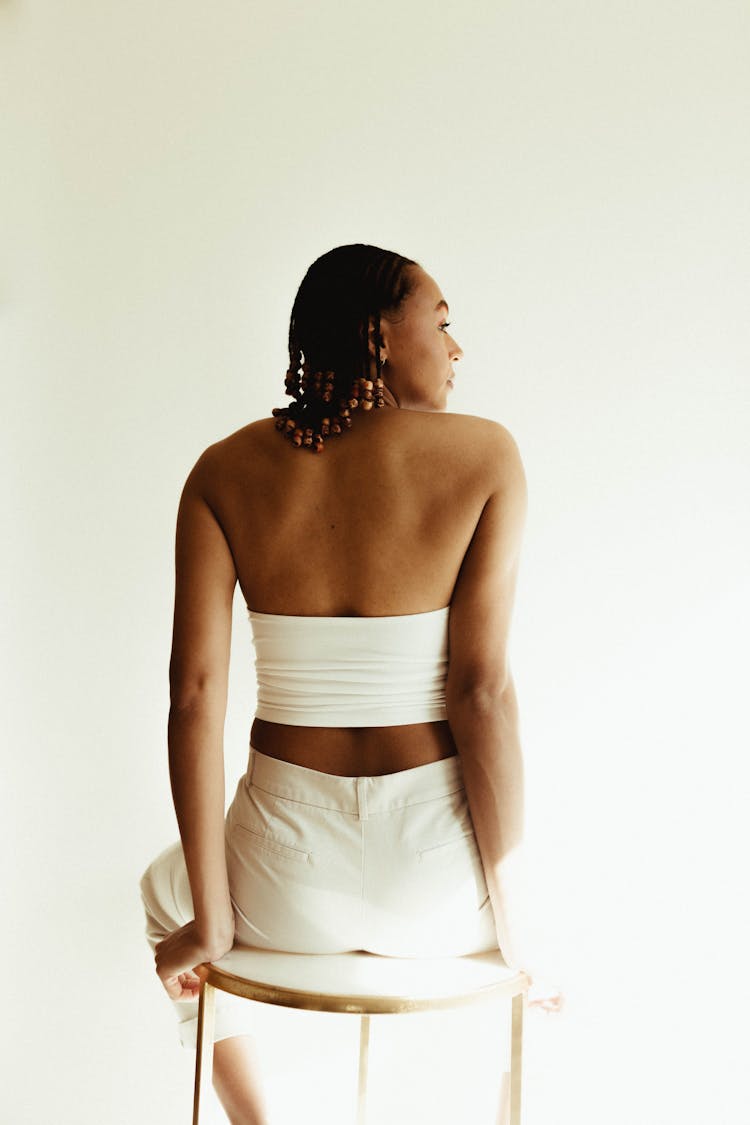 Woman In White Tube Top Sitting On A Stool