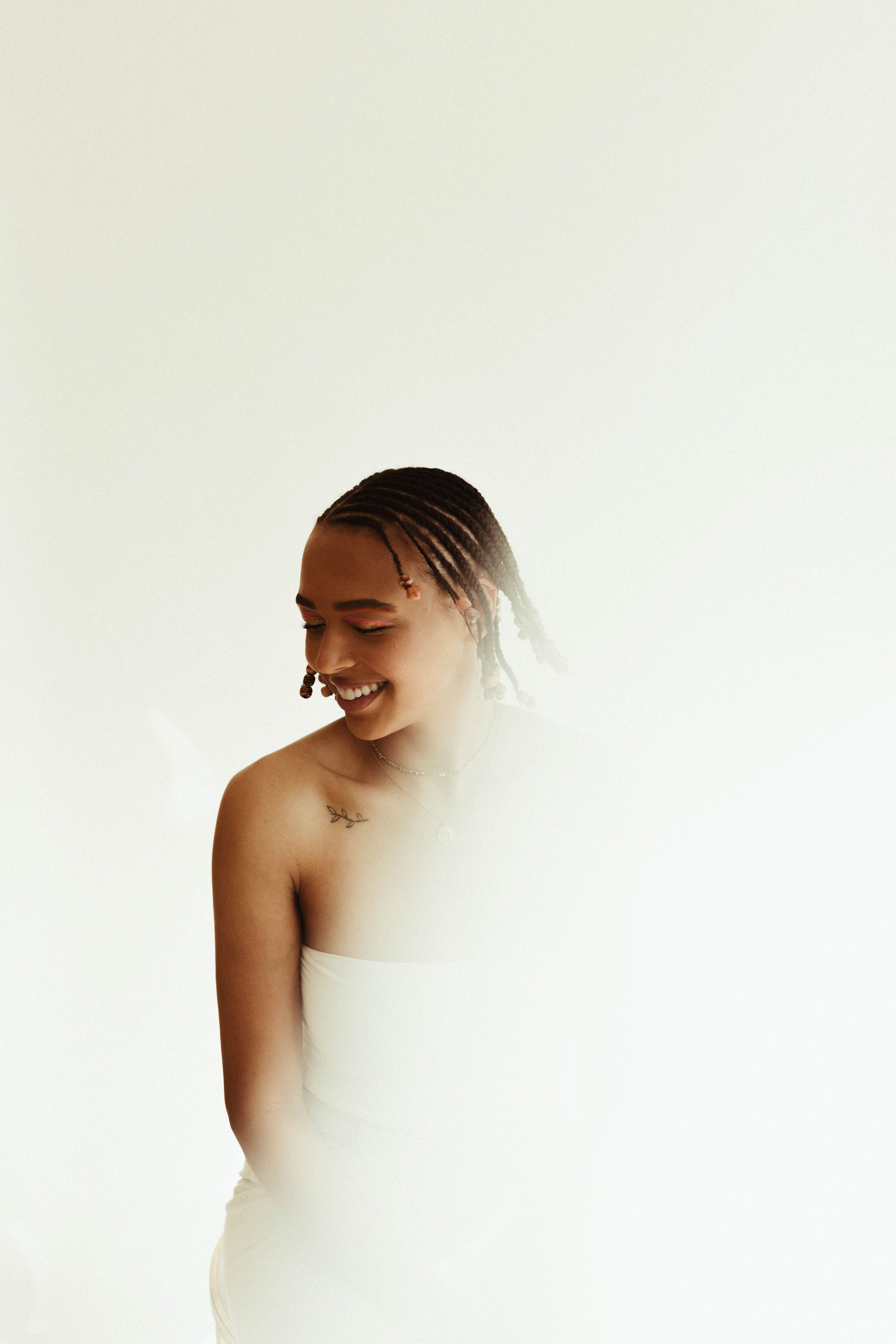 A Woman in White Long Sleeve Shirt Sitting on the Floor · Free Stock Photo