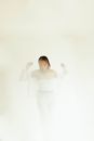 Woman in White Long Sleeve Shirt and White Pants