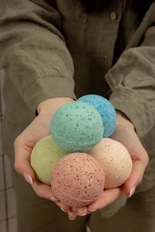 Colorful Bath Bombs on Person's Hands
