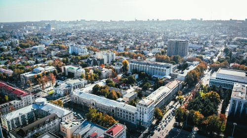 Free Stunning aerial view of a bustling urban cityscape with roads and buildings. Stock Photo