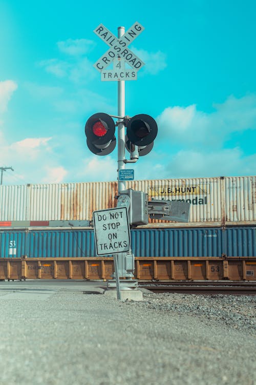 Cargo Train Passing a Railroad Crossing