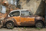 Brown Car Parked Beside Brown Brick Wall