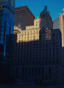 Historic architecture in Toronto blends with modern skyscrapers, highlighting urban contrast.
