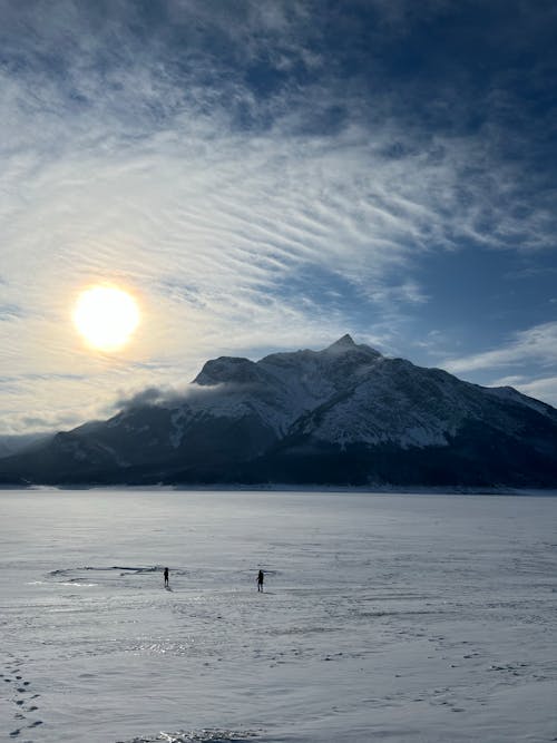 People Standing on a Snow Covered Field