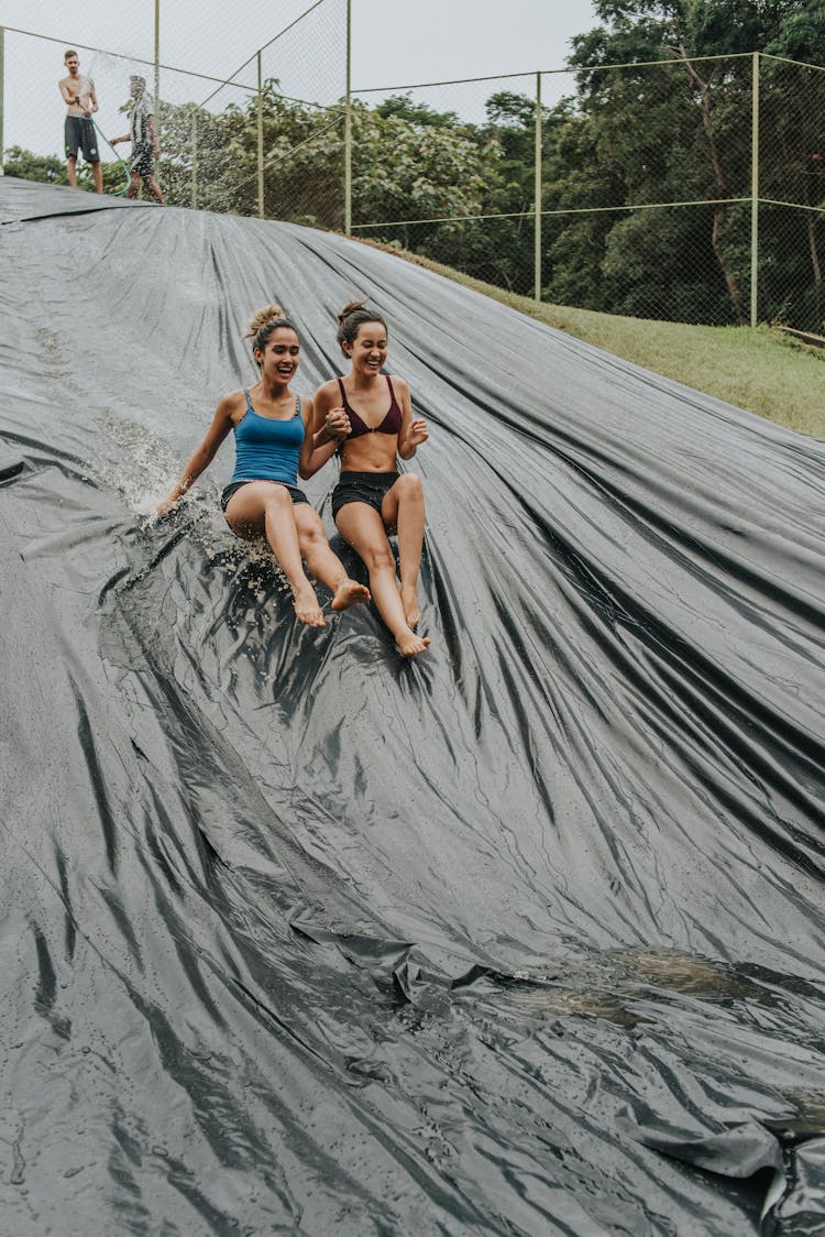 Women Enjoying The Waterslide