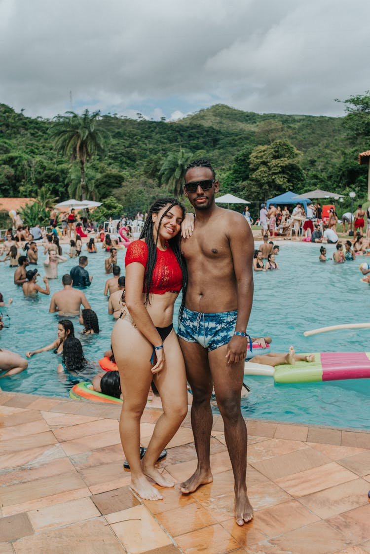 A Couple Standing At The Poolside