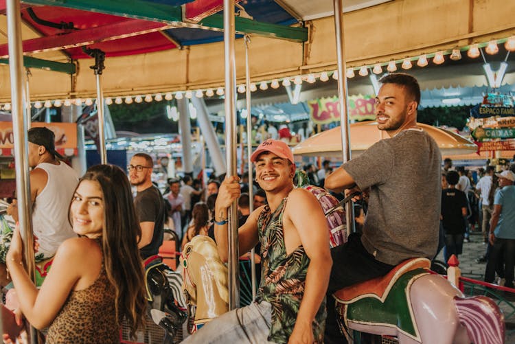 A Group Of People Riding A Carousel