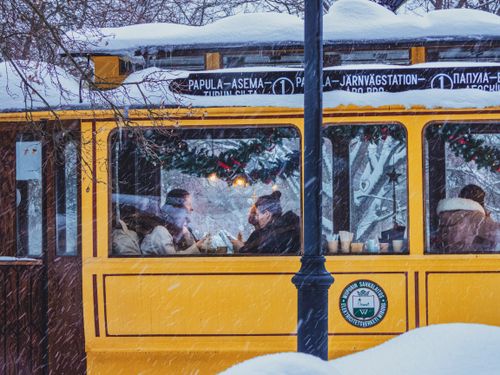 Free A cozy tram ride through snowy streets, capturing winter's essence and holiday charm. Stock Photo