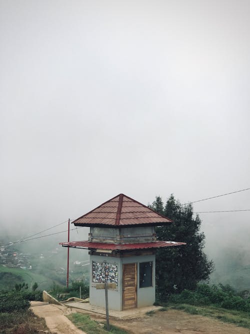 Small Building in Fog on Hill