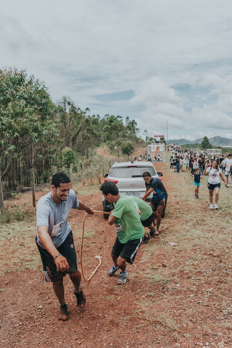 Men Pulling Car On Rope