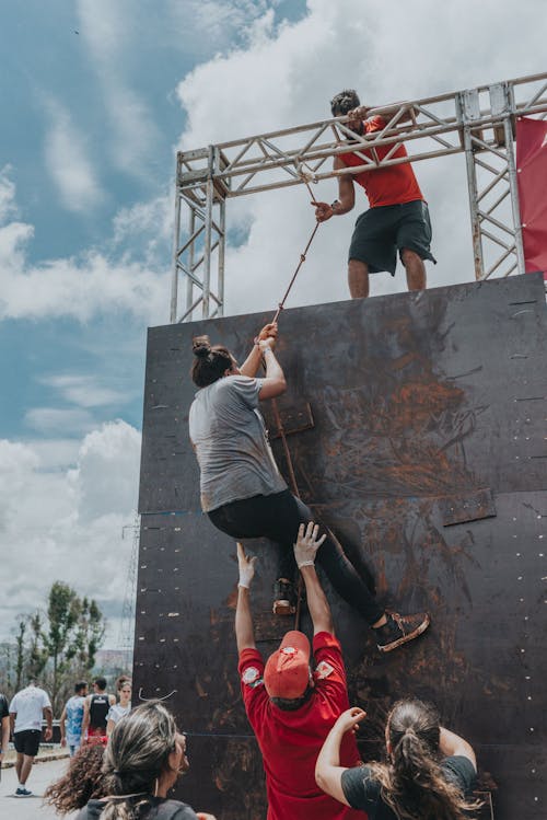 Free A Participant Climbing a Wall Using a Rope Stock Photo