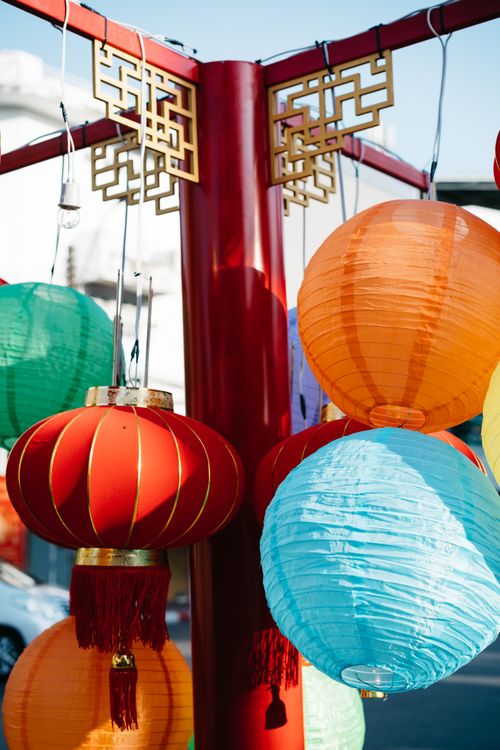 Free Colorful Chinese lanterns hanging outdoors, creating a festive atmosphere. Stock Photo