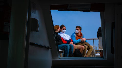 Photo of People Wearing Face Masks Travelling on a Ferry