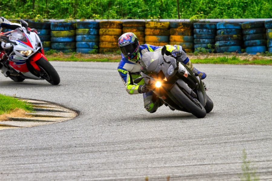 Sport motorcycles leaning through a race track corner