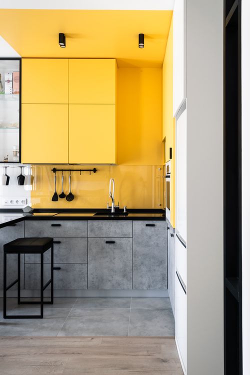 Free Bright yellow and gray kitchen with minimalist design in St. Petersburg. Stock Photo