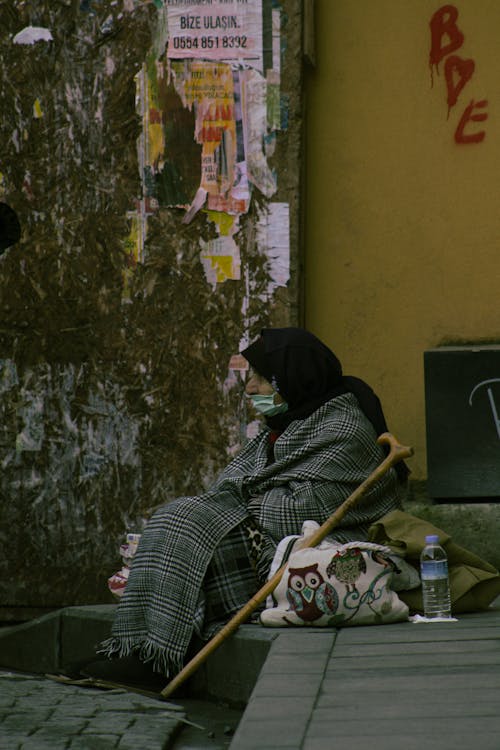 A Homeless Woman Draped Wrapped with Blanket