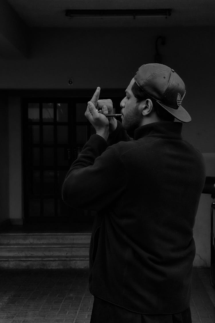 Black And White Photo Of A Man Smoking Cigar