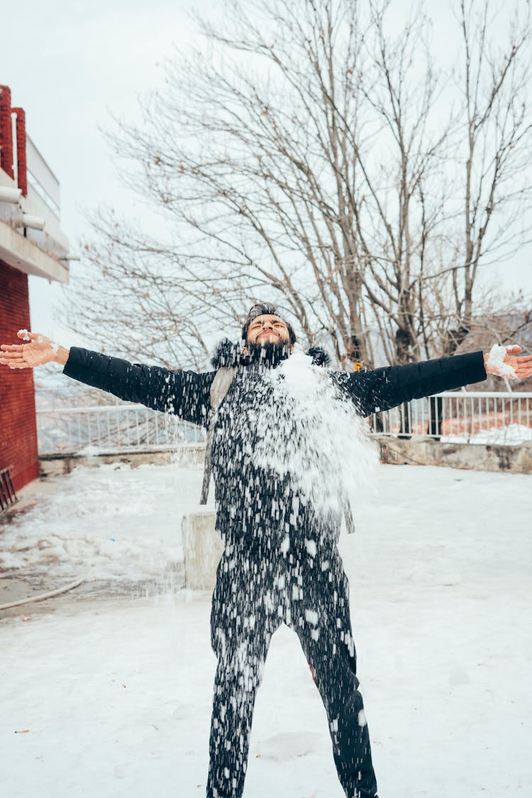 Man Throwing Around Snow