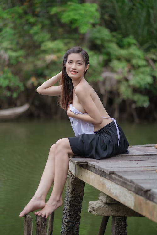 Sexy Woman Sitting on a Dock