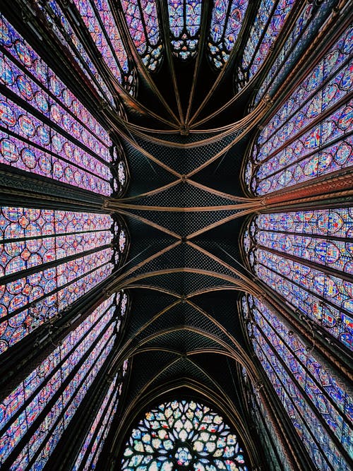 Low Angle Shot of a Gothic Chapel Ceiling and Stain Glass Windows