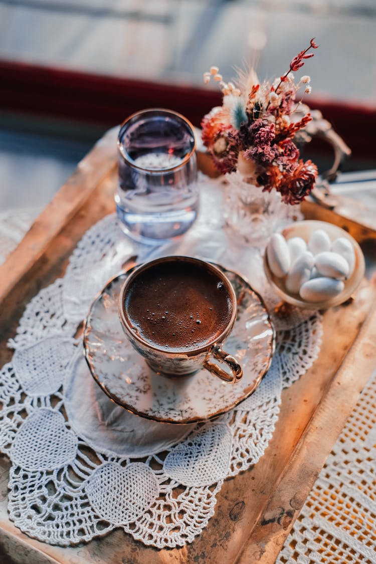 Cup Of Coffee With Sweets And Glass Of Water