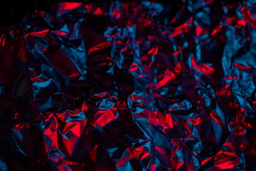 Red Neon Light on Crumpled Foil Surface
