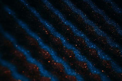 Red and Blue Glitters in Close-up Photography