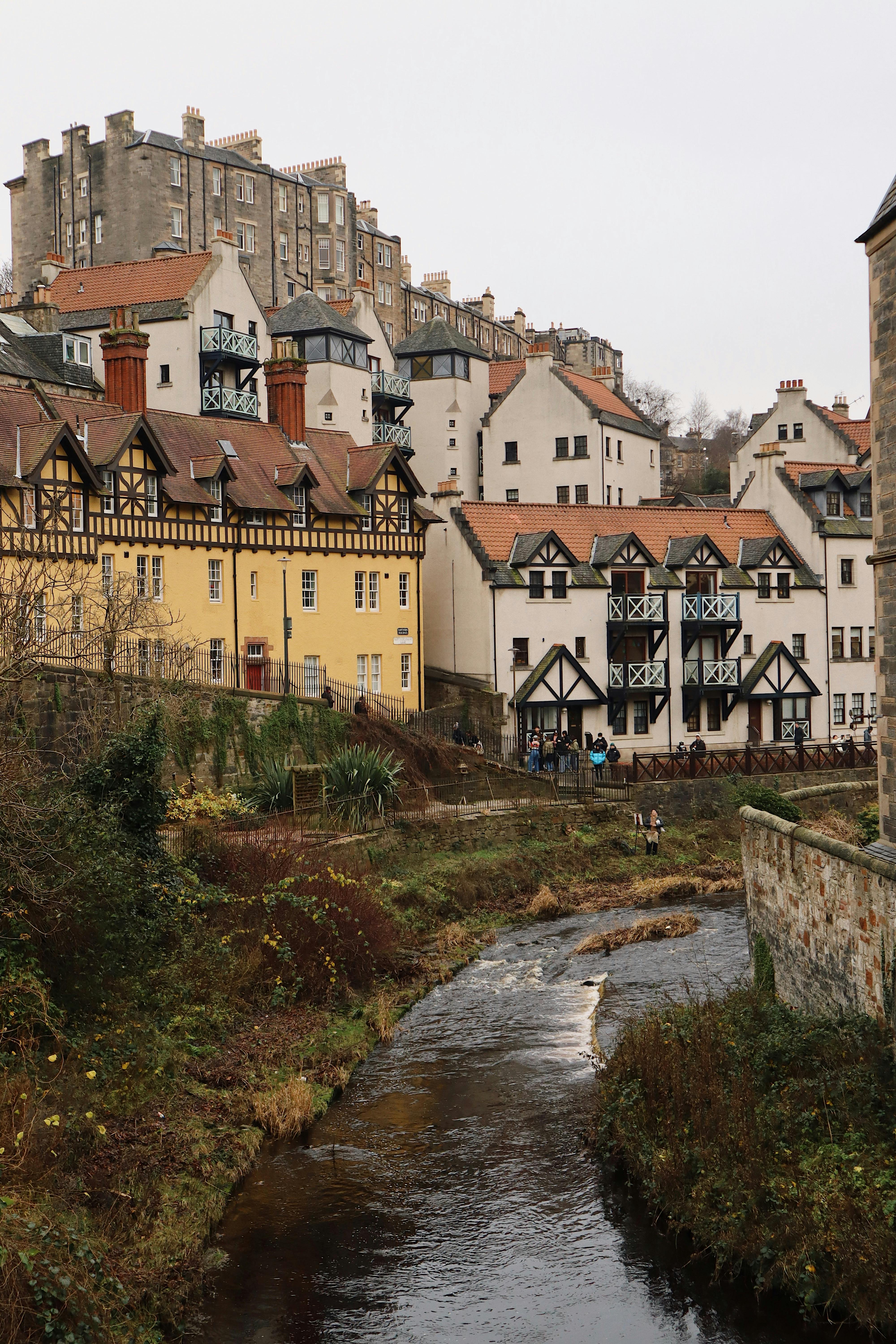 Picturesque village with creek and historic architecture on an overcast autumn day.