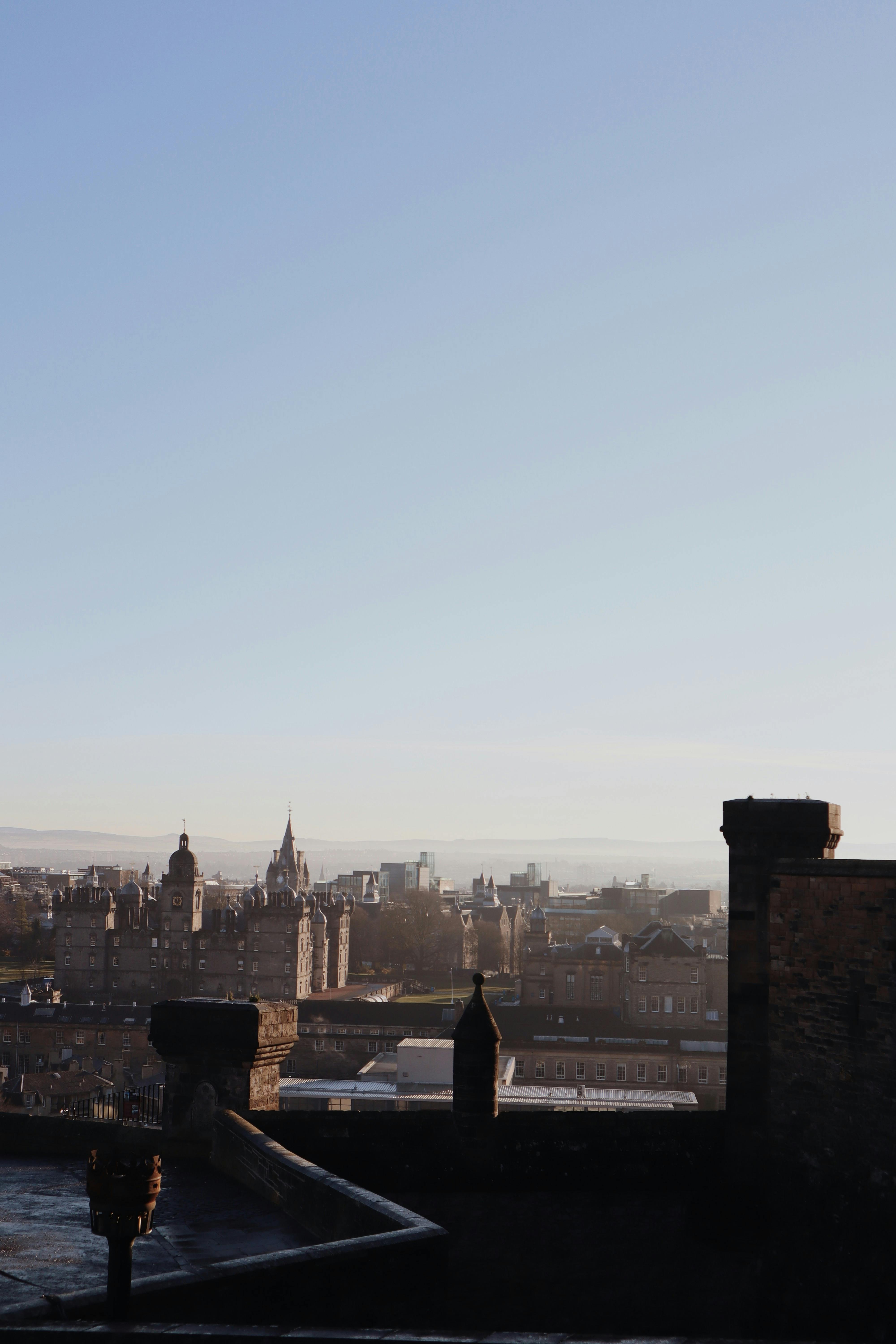 Panoramic view of Edinburgh's historic skyline with clear blue skies.