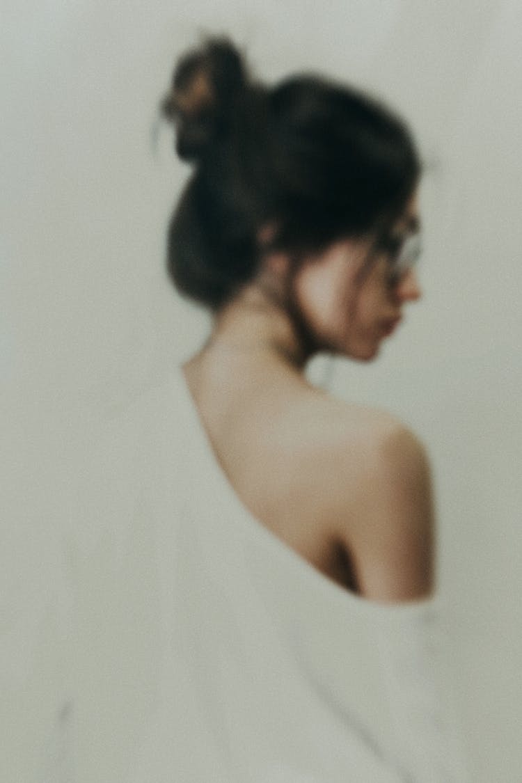 Back View Of A Woman In White Top