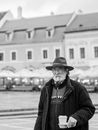 Man in Black Jacket and Hat Standing Near Body of Water