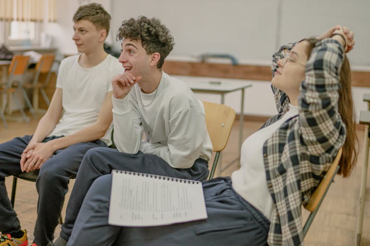 Men And Woman Sitting In Classroom