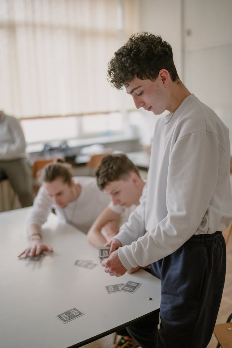 Boys Playing Cards In School
